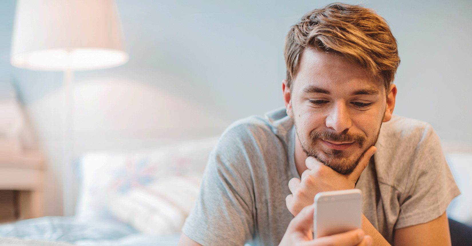 He is lying. Парень читает телефон. Man with iphone. Happy man with Phone. Парень читает смс.